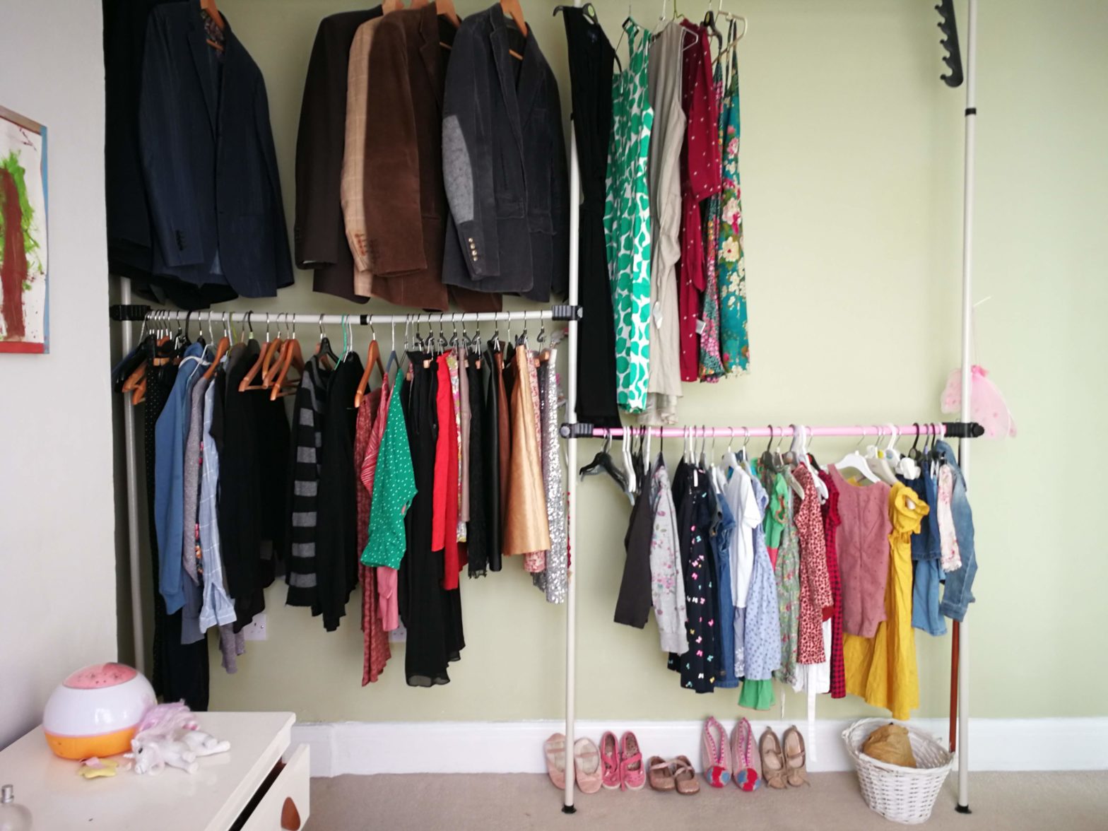 Colourful women's and girls' boutique closet, with a stylish display of clothes and shoes.