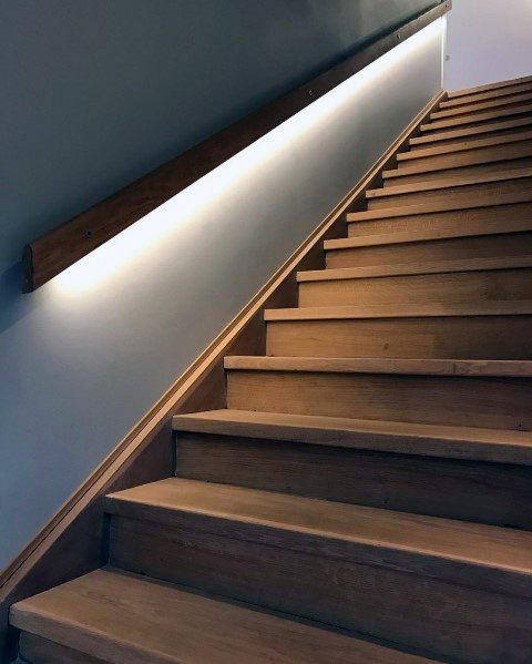contemporary wooden staircase with a light-feature wall. 